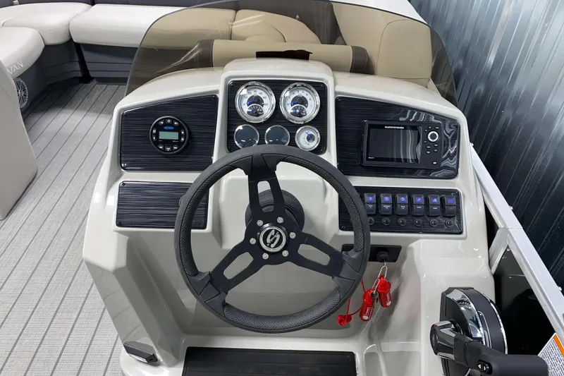 Slide: The Image of 2026 Sylvan Mirage 8522 LZ boat dashboard with steering wheel and control panel. - 7