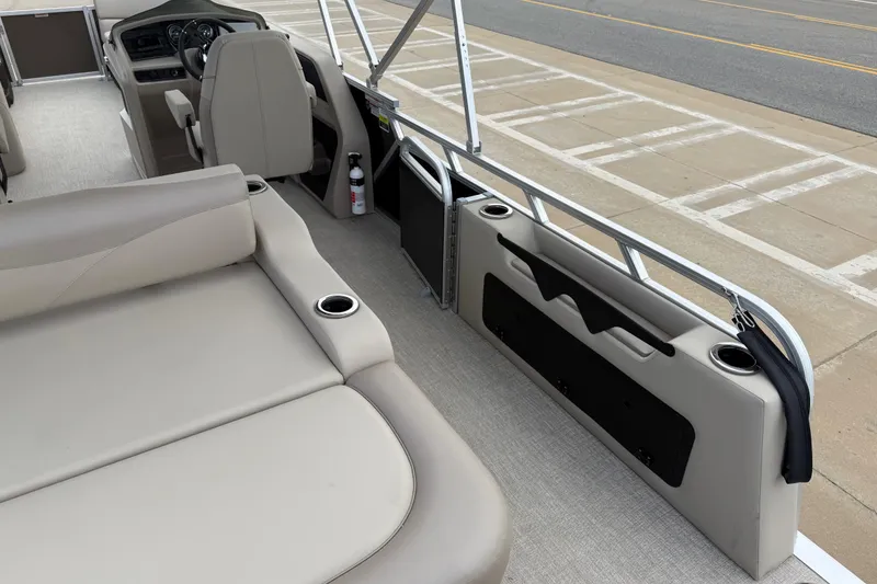 Slide: The Image of 2026 Avalon LSZ Versatile Rear Bench boat interior with beige seating and steering console. - 28