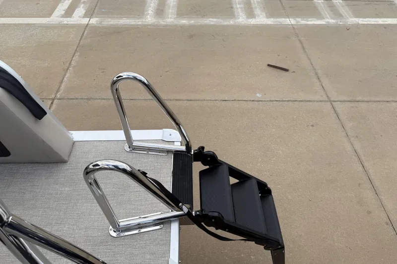 Slide: The Image of 2026 Avalon LSZ Versatile Rear Bench with stainless steel boat ladder on dock. - 29