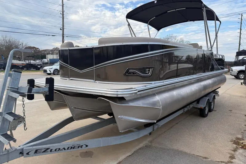 Slide: The Image of 2026 Avalon LSZ Versatile Rear Bench pontoon boat on trailer, featuring sleek design and canopy. - 3