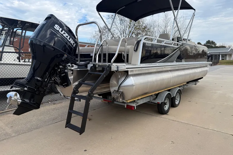 Slide: The Image of 2026 Avalon LSZ Versatile Rear Bench pontoon boat with Suzuki outboard motor on trailer. - 5