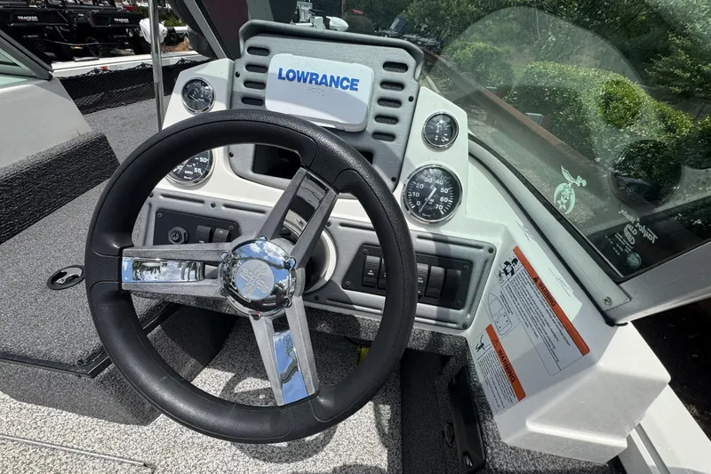 Slide: The Image of 2020 Ranger VS1682 WT boat dashboard with steering wheel and Lowrance display. - 6