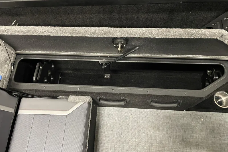 Slide: The Image of 2026 Alumacraft Competitor 175X Sport interior storage compartment with seating and cup holder. - 10