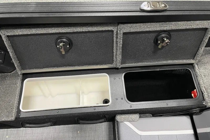 Slide: The Image of 2026 Alumacraft Competitor 175X Sport storage compartments with secure locks and organized interior. - 11