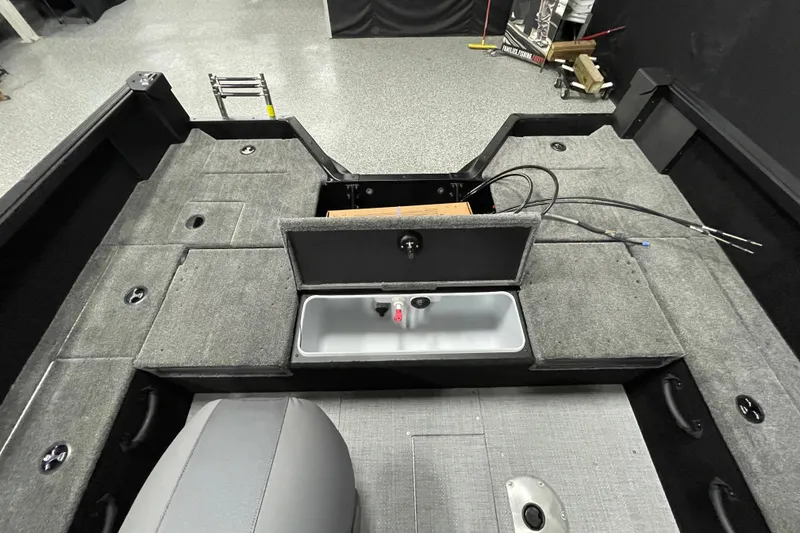 Slide: The Image of 2026 Alumacraft Competitor 175X Sport boat interior with storage compartments and seating. - 13