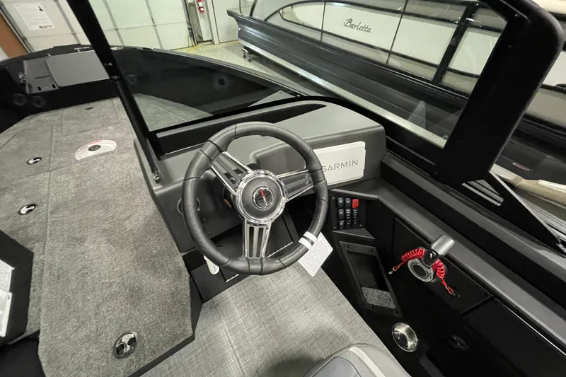 Slide: The Image of Interior of 2026 Alumacraft Competitor 175X Sport boat with steering wheel and Garmin system. - 14