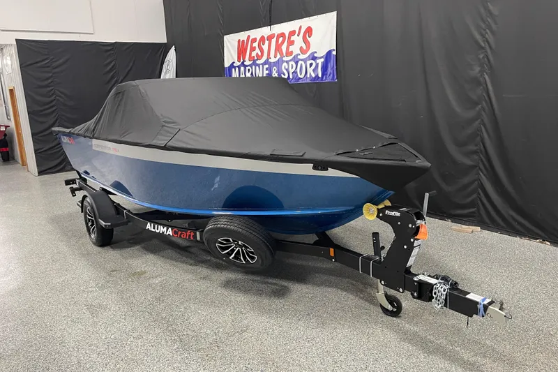 Slide: The Image of 2026 Alumacraft Competitor 175X Sport boat with cover on trailer in showroom. - 18