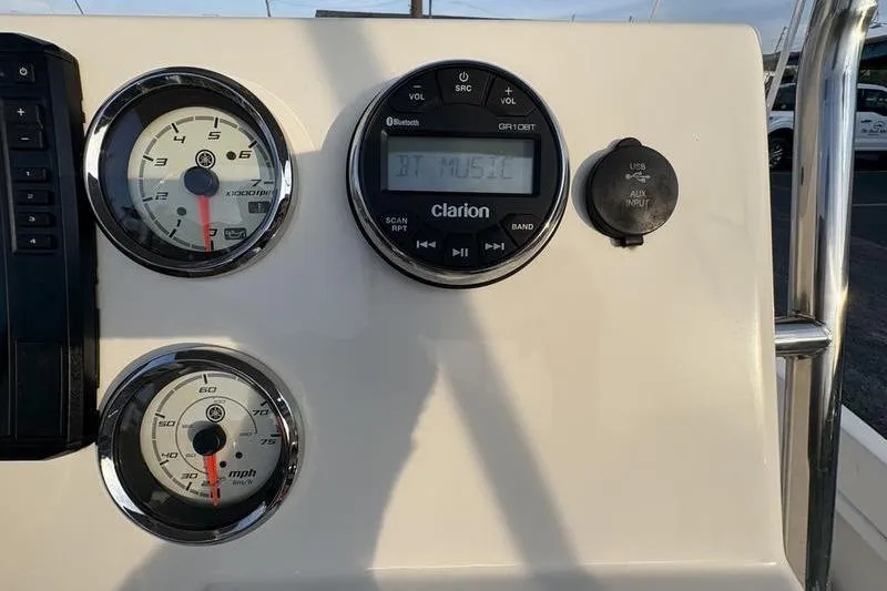Slide: The Image of 2023 Key West 1720 Center Console dashboard with gauges and Clarion audio system. - 16