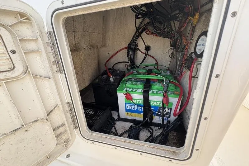Slide: The Image of Battery compartment of 2023 Key West 1720 Center Console boat, featuring Interstate deep cycle battery. - 21
