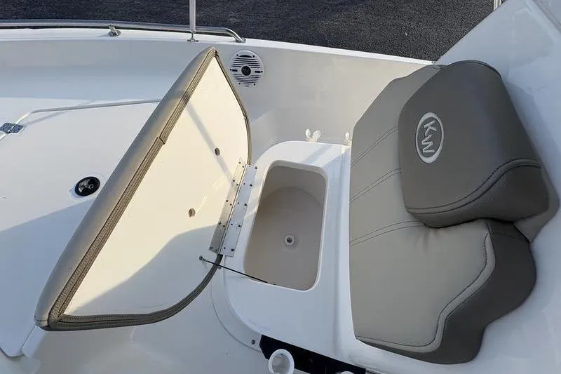Slide: The Image of 2023 Key West 1720 Center Console boat interior with storage compartment and cushioned seat. - 24