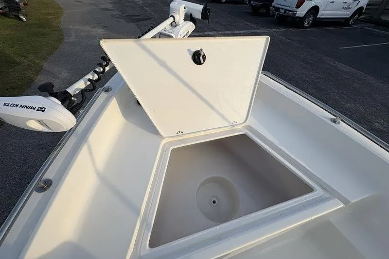 Slide: The Image of 2023 Key West 1720 Center Console boat with open storage compartment and trolling motor. - 25