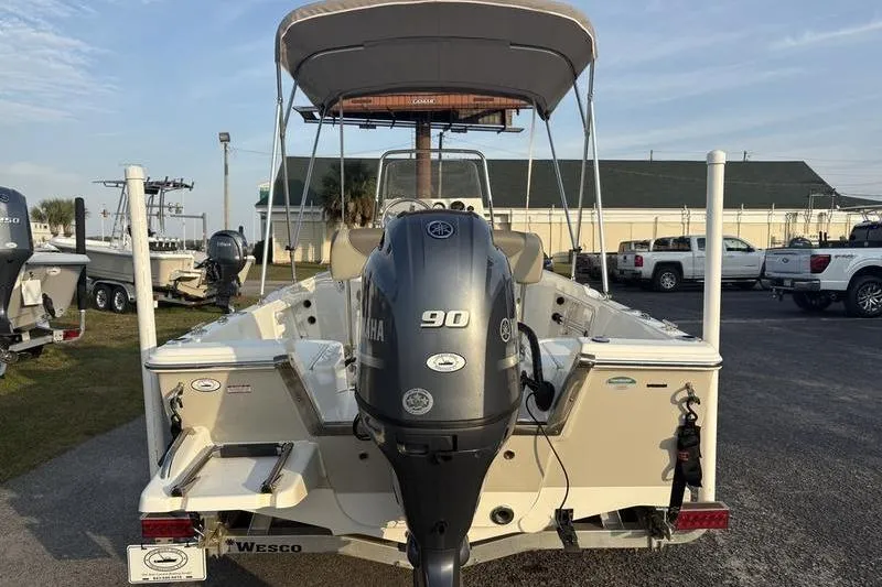 Slide: The Image of 2023 Key West 1720 Center Console boat with Yamaha 90 engine, parked outdoors. - 3