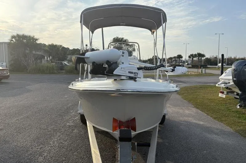 Slide: The Image of 2023 Key West 1720 Center Console boat with canopy on trailer, parked outdoors. - 7