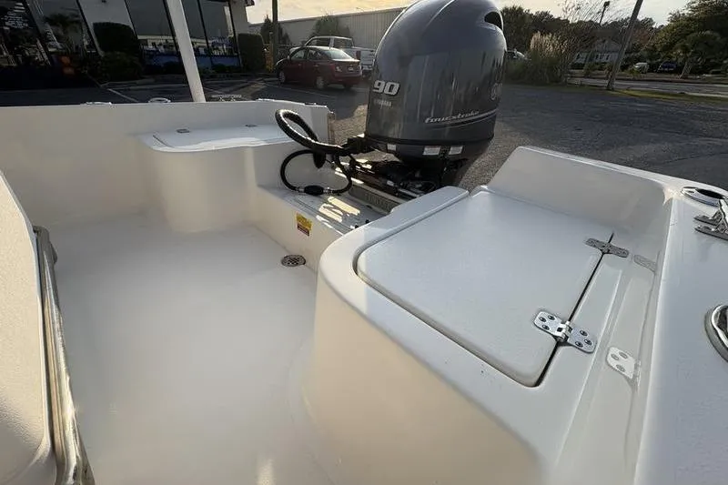 Slide: The Image of 2023 Key West 1720 Center Console boat with Yamaha 90 engine, docked outdoors. - 9