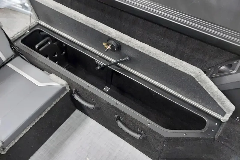 Slide: The Image of 2026 Alumacraft Competitor 175X Sport interior storage compartment with seating detail. - 11