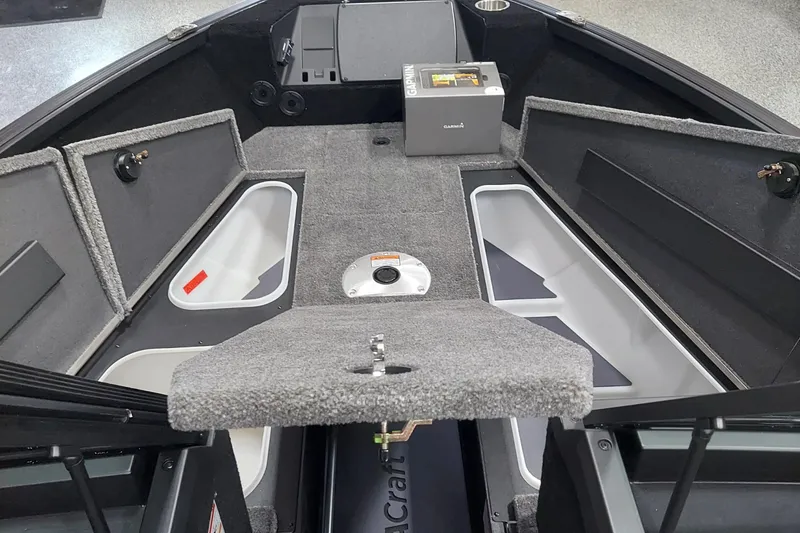 Slide: The Image of 2026 Alumacraft Competitor 175X Sport boat interior with storage compartments and Garmin equipment. - 6