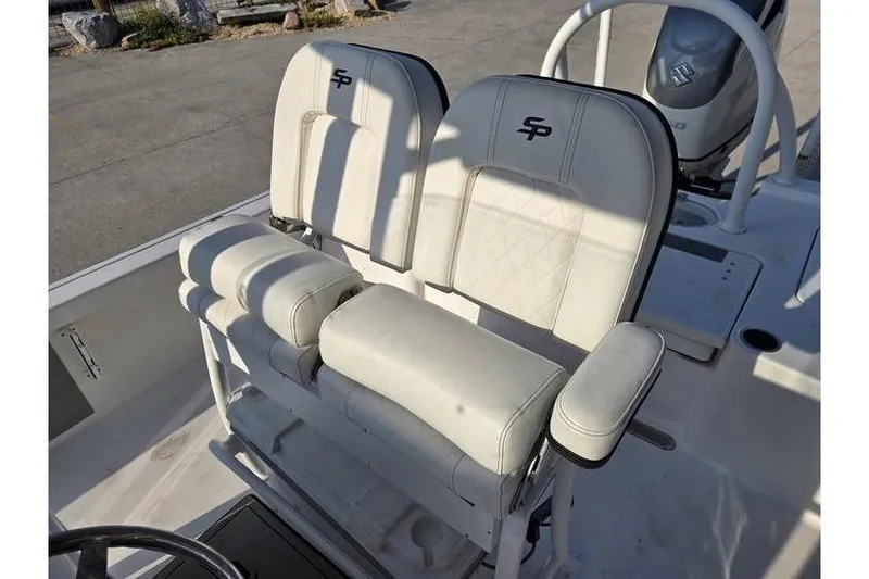 Slide: The Image of 2021 Sea Pro 248 Bay boat seats with white upholstery and armrests. - 11