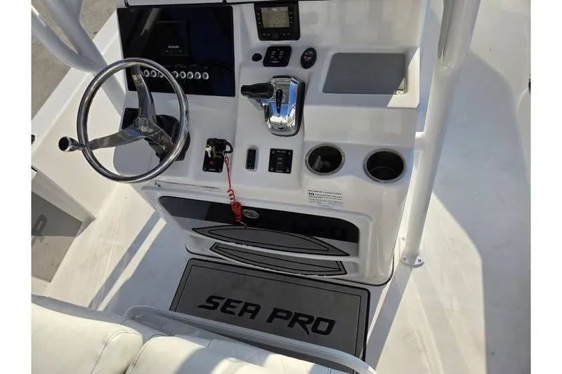 Slide: The Image of 2021 Sea Pro 248 Bay boat console with steering wheel and controls. - 14