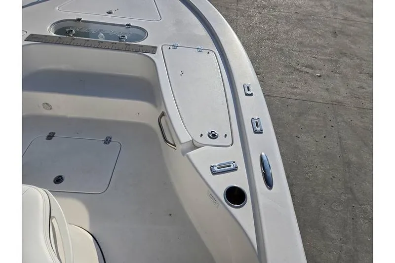 Slide: The Image of 2021 Sea Pro 248 Bay boat deck with storage compartments and cup holder. - 9