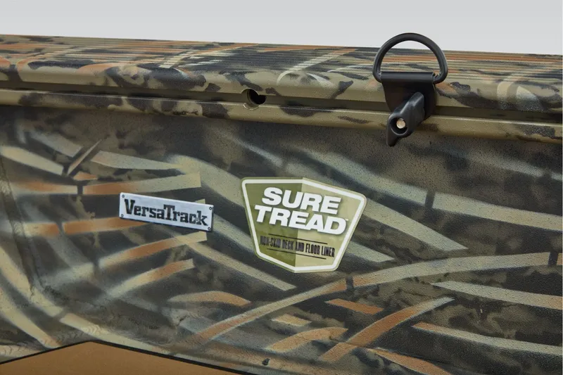 Slide: The Image of 2026 Tracker Grizzly 1756 T Marsh boat with camo design, featuring VersaTrack and Sure Tread logos. - 14