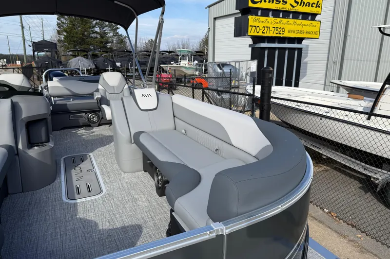 Slide: The Image of 2026 Avalon LSZ Versatile Rear Lounger boat with luxurious seating at a dealership. - 13