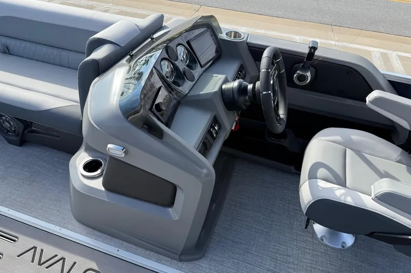 Slide: The Image of 2026 Avalon LSZ Versatile Rear Lounger boat interior with modern dashboard and seating. - 21