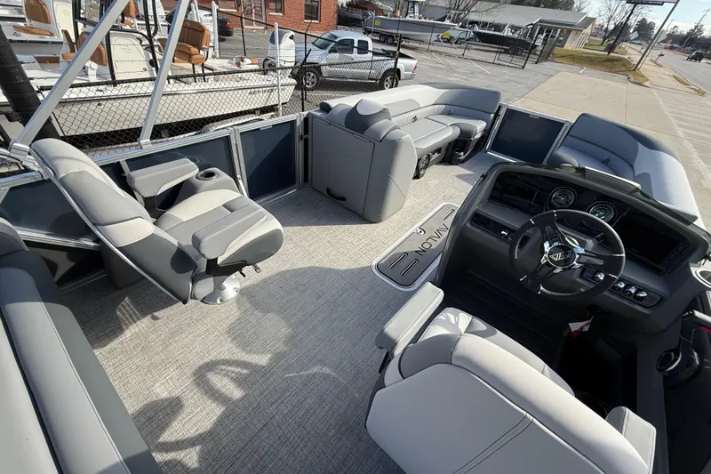 Slide: The Image of 2026 Avalon LSZ Versatile Rear Lounger boat interior with plush seating and modern dashboard. - 30