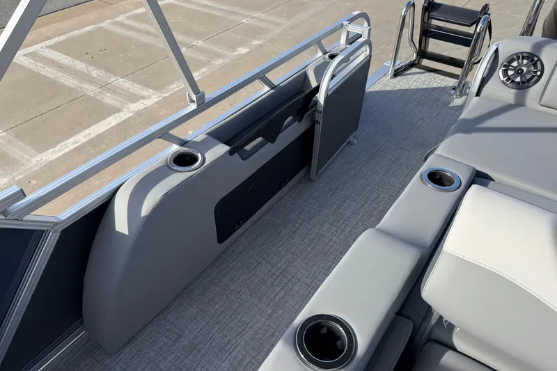 Slide: The Image of 2026 Avalon LSZ Versatile Rear Lounger boat interior with cup holders and seating. - 38