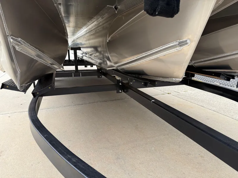 Slide: The Image of 2025 Avalon LSZ Versatile Rear Lounger pontoon boat underside on trailer. - 44