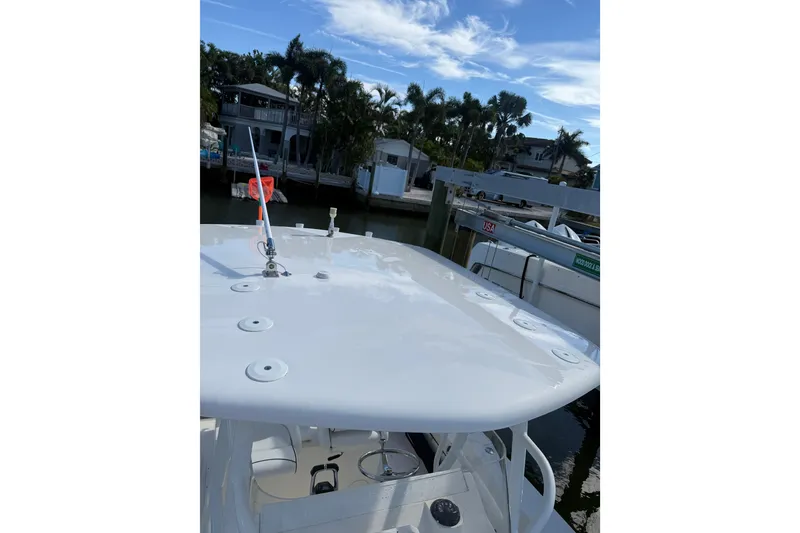 Slide: The Image of 2017 Stamas 308 Predator boat docked near palm trees and waterfront homes. - 13
