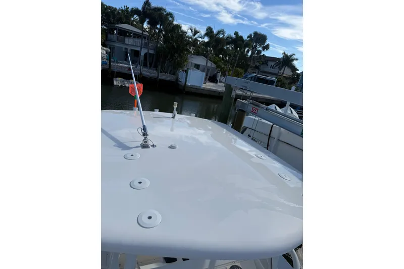 Slide: The Image of 2017 Stamas 308 Predator boat docked near waterfront homes and palm trees. - 14