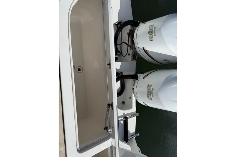 Slide: The Image of 2017 Stamas 308 Predator boat with twin 300 horsepower engines, open storage compartment. - 16