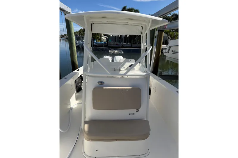 Slide: The Image of 2017 Stamas 308 Predator boat interior with seating and helm, docked by the water. - 18