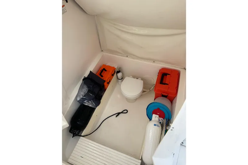 Slide: The Image of Interior of 2017 Stamas 308 Predator boat with toilet and storage items. - 24