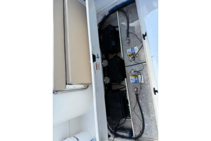 Slide: The Image of 2017 Stamas 308 Predator boat battery compartment with wiring and storage. - 25