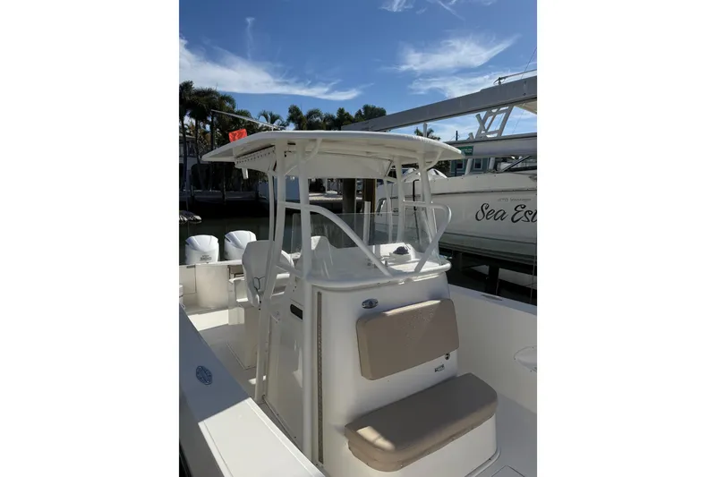 Slide: The Image of 2017 Stamas 308 Predator boat with center console and seating, docked under a clear sky. - 27