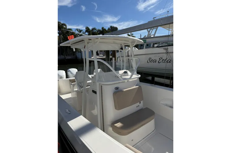 Slide: The Image of 2017 Stamas 308 Predator boat with seating and console, docked under a clear sky. - 29