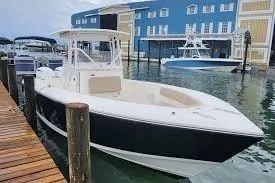 Slide: The Image of 2017 Stamas 308 Predator boat docked near blue building. - 3