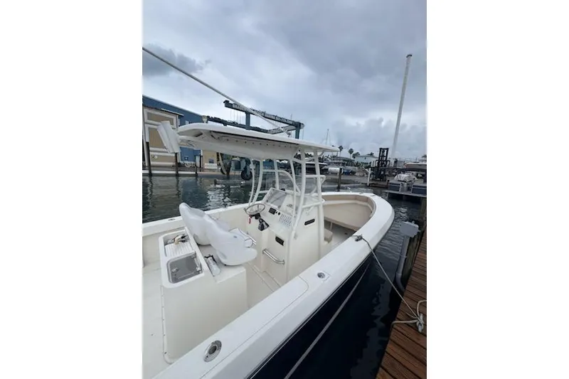 Slide: The Image of 2017 Stamas 308 Predator boat docked at marina under cloudy sky. - 8