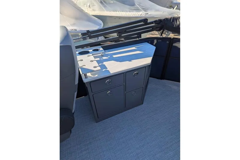 Slide: The Image of 2025 Berkshire 22CL CTS 3.0 boat interior with storage cabinet and cup holders. - 10