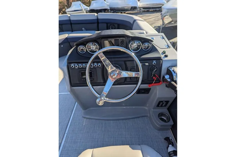 Slide: The Image of 2025 Berkshire 22CL CTS 3.0 boat dashboard with steering wheel and controls. - 11