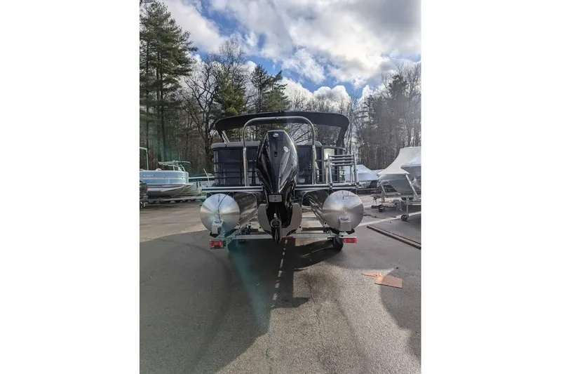 Slide: The Image of 2025 Berkshire 22CL CTS 3.0 pontoon boat on trailer, parked outdoors under cloudy sky. - 3