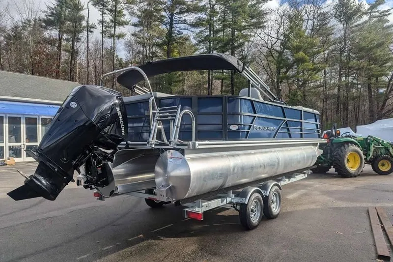 Slide: The Image of 2025 Berkshire 22CL CTS 3.0 pontoon boat with Mercury outboard motor on trailer. - 4