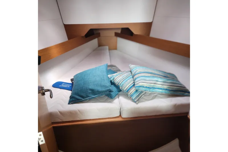 Slide: The Image of Cozy cabin interior of 2023 Jeanneau Sun Odyssey 349 with striped cushions. - 13