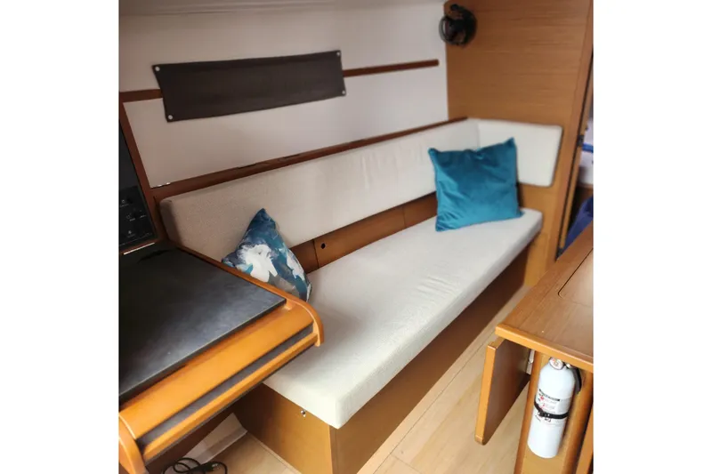 Slide: The Image of Interior of 2023 Jeanneau Sun Odyssey 349 with cushioned seating and decorative pillows. - 14
