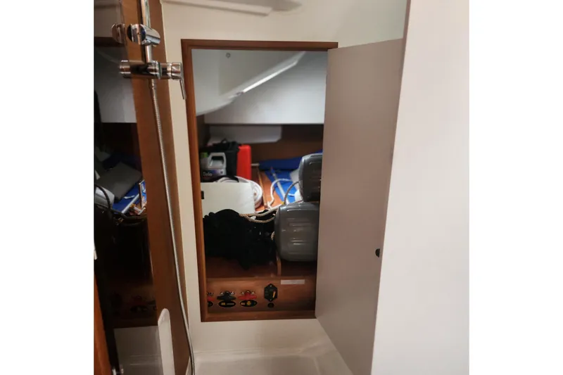 Slide: The Image of Interior view of 2023 Jeanneau Sun Odyssey 349 sailboat cabin with storage area. - 19