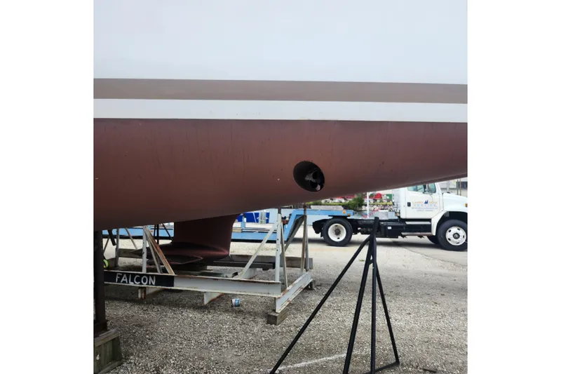 Slide: The Image of 2023 Jeanneau Sun Odyssey 349 hull on stand, showcasing propeller and keel. - 21