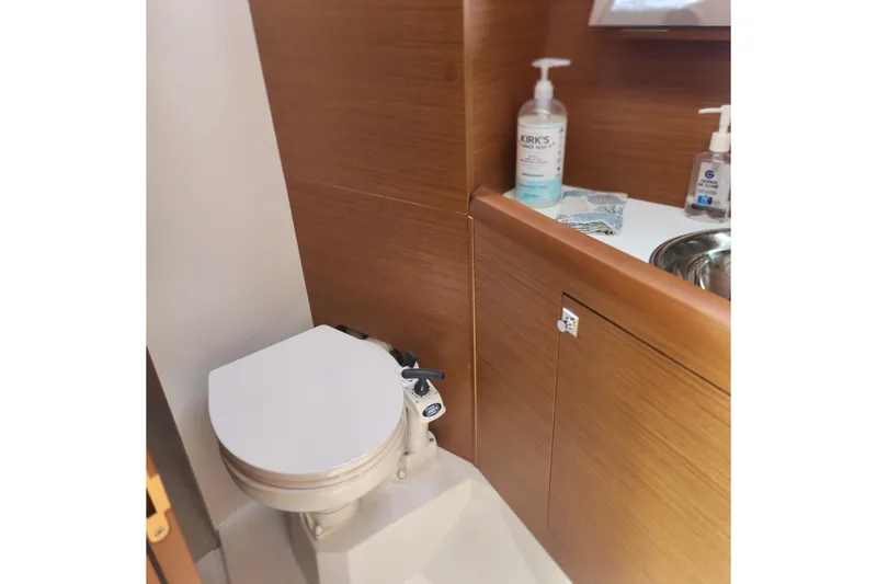 Slide: The Image of Bathroom interior of 2023 Jeanneau Sun Odyssey 349 yacht, featuring toilet and sink. - 23