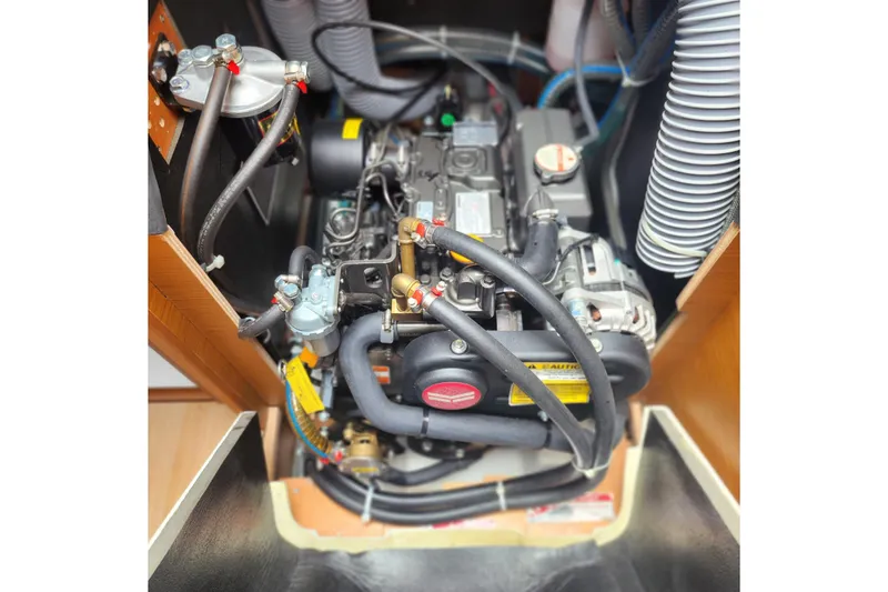 Slide: The Image of Engine compartment of 2023 Jeanneau Sun Odyssey 349 sailboat, showcasing detailed mechanical components. - 24