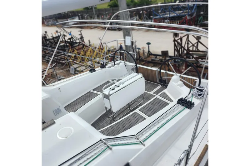 Slide: The Image of 2023 Jeanneau Sun Odyssey 349 yacht cockpit with dual steering wheels and teak flooring. - 7